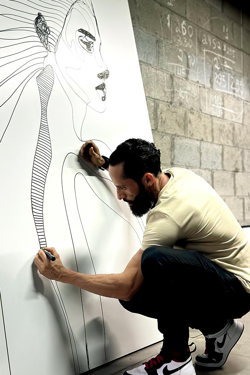 Juca Maximo creating a large-scale emotional line art portrait from the Traces series — behind-the-scenes in the artist's studio.