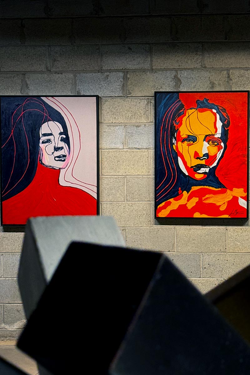 Portrait Colors series by Juca Maximo displayed in a concrete art space, blending expressionism and vibrant palette in emotional female figures.