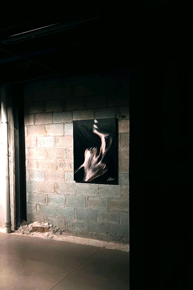 Raw exhibition space showcasing Juca Máximo’s sensual abstract painting — highlighting the contrast between urban texture and expressive feminine energy.