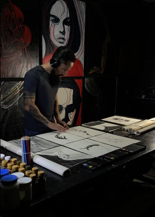 Artist performing a dynamic large-scale painting gesture on a floor canvas using black ink in a spacious gallery hall.