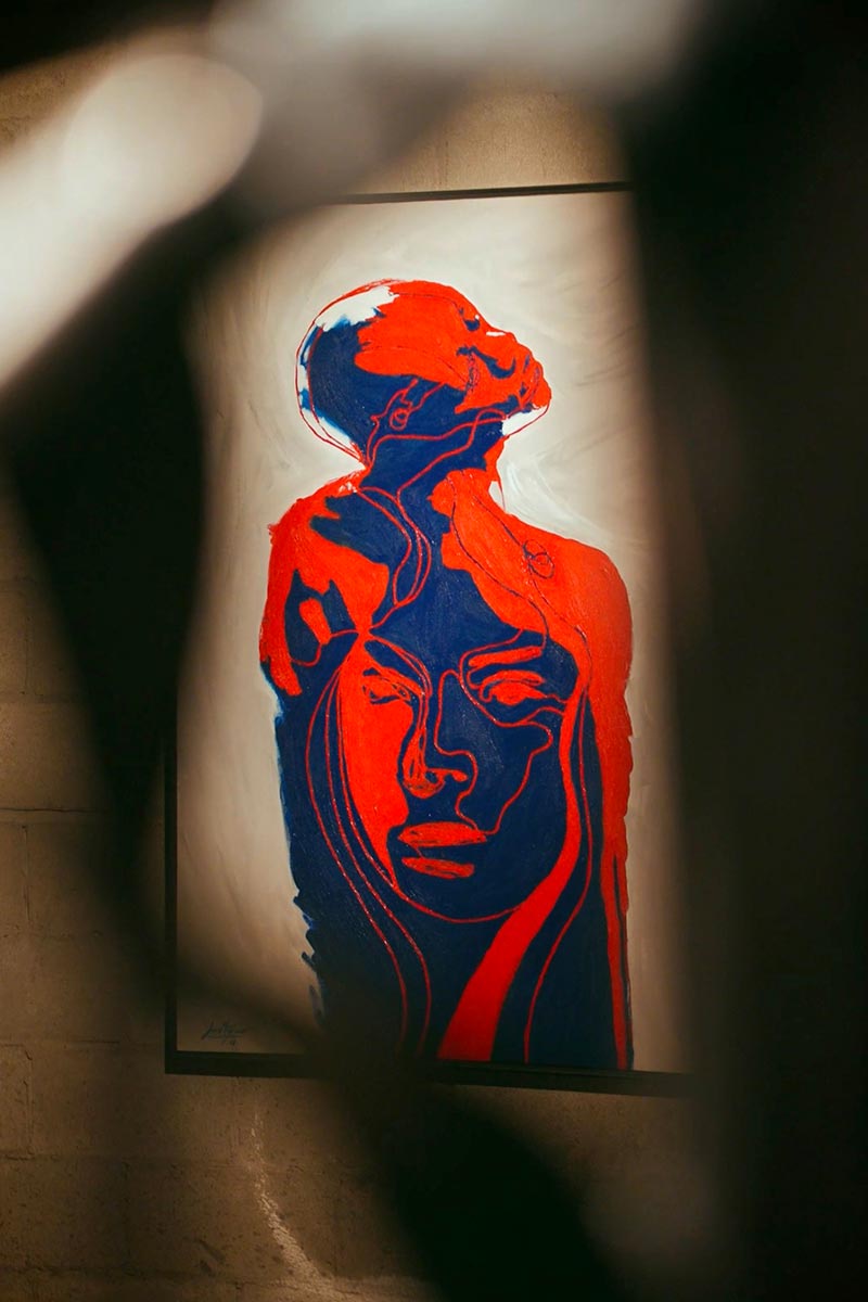 Conceptual artwork from the Skin That I Feel series by Juca Máximo, featuring overlapping emotional silhouettes in vibrant red and deep blue tones.