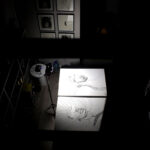 Contemporary artist studio with large canvas drawings in black ink on table, overhead view of artwork in progress, Traces series by Brazilian artist Juca Máximo